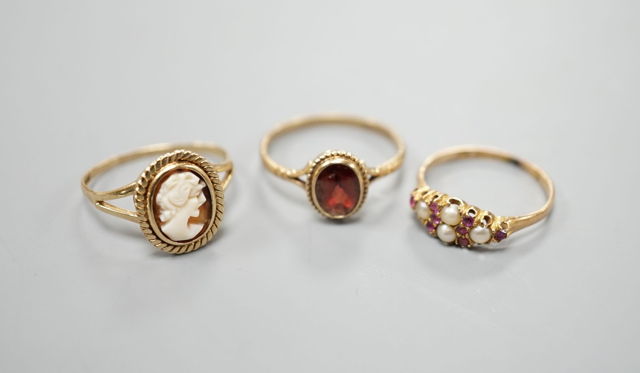 A late Victorian 15ct gold, seed pearl and amethyst cluster set ring, size L, gross 2.1 grams and two later 9ct gold rings including cameo shell, gross 3.2 grams.